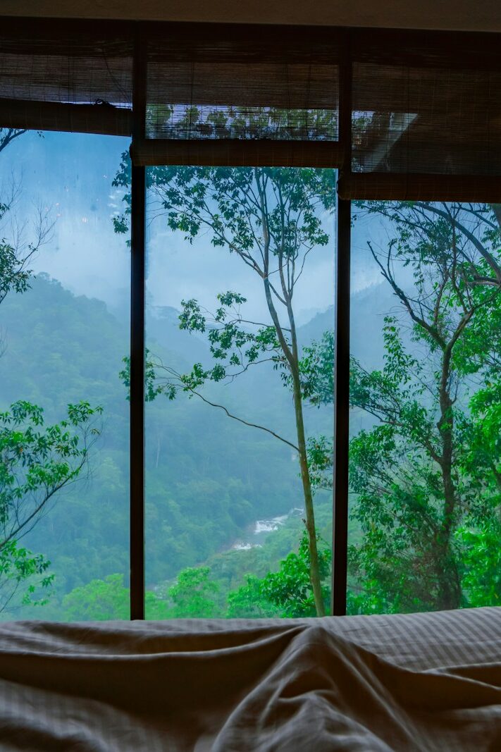 a bedroom with a view of the mountains outside the window, unique accommodation display